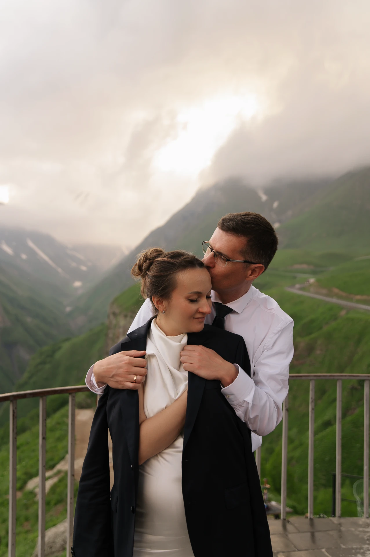 The bride and groom against the backdrop of the mountains in Gudauri Georgia